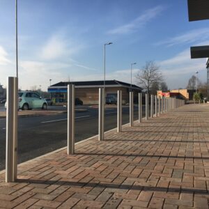 A row of the Stainless Steel Grade 304 Bollard - Concrete In along a public walkway