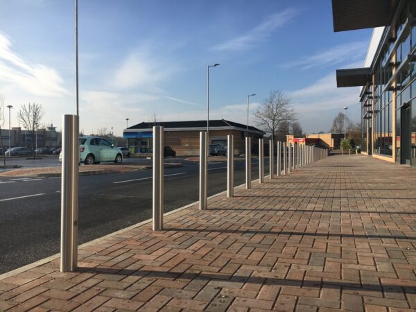 A row of the Stainless Steel Grade 304 Bollard - Concrete In along a public walkway