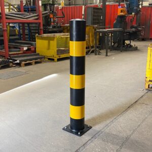 Galvanised High Vis Black and Yellow Bolt Down Bollard installed in a warehouse